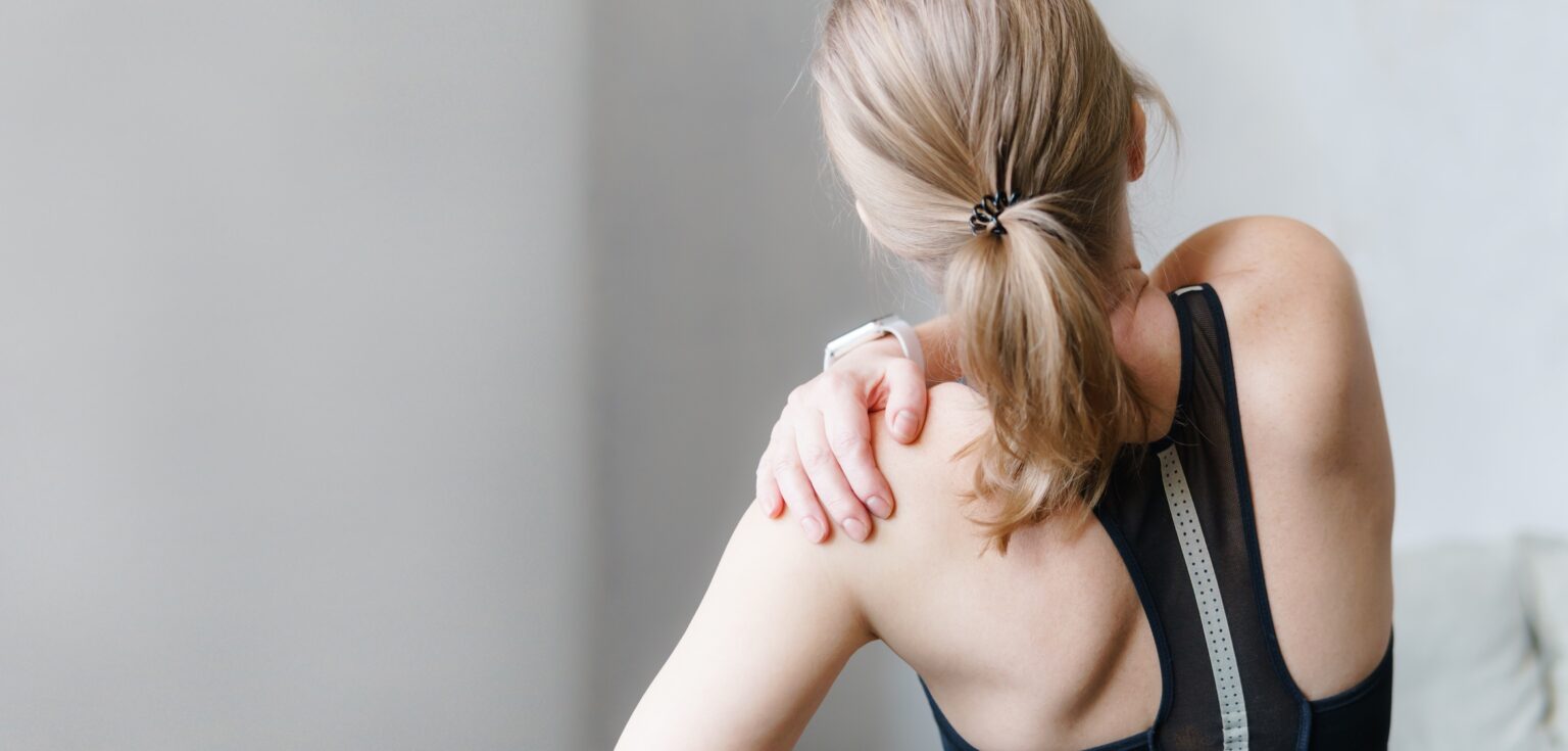 The Value of Supplements for Muscle Soreness Woman with muscle soreness on her shoulder