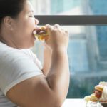 Close,Up,Of,Greedy,Fat,Woman,Eating,A,Burger,While